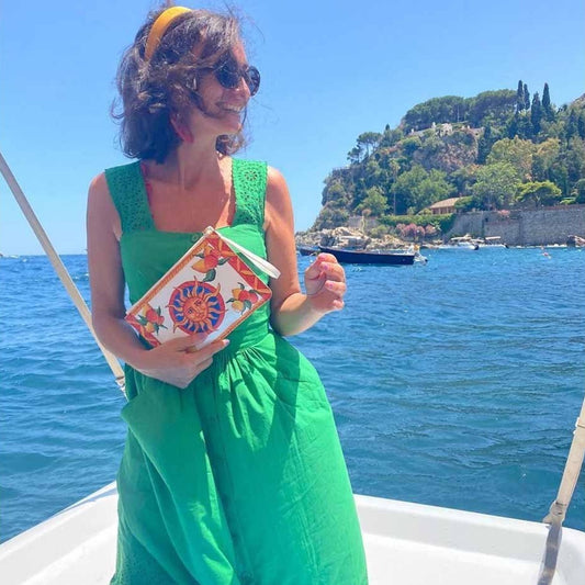 Model in green dress enjoys Bam Bar Taormina inspired purse by DOLCE ITALIANA