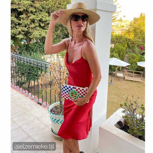 Cherry bag worn by model in red dress