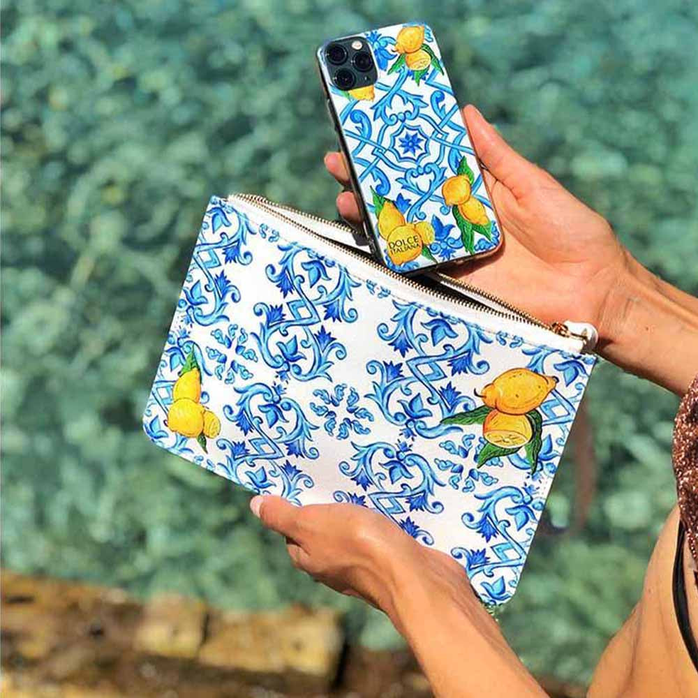 Lemon and blue Maiolica tiles DOLCE design purse and phone case at beach
