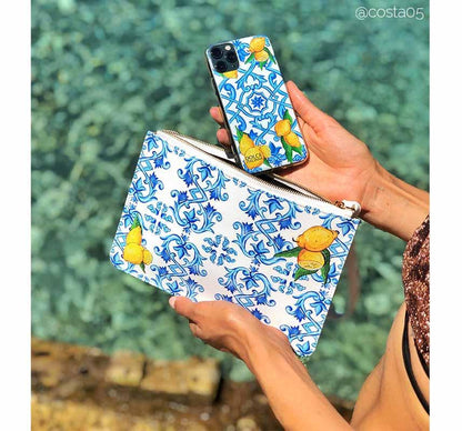 Lemon and blue Maiolica tiles DOLCE design purse and phone case at beach
