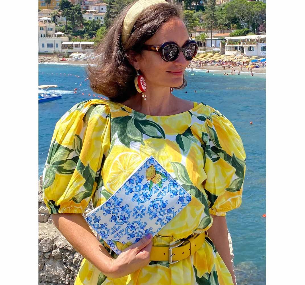 Clutch Bag-DOLCE ITALIANA-Traditional handpainted Italian design purse pouch featuring Capri lemons and blue Amalfi Coast maiolica tile design worn by pretty girl in lemon dress