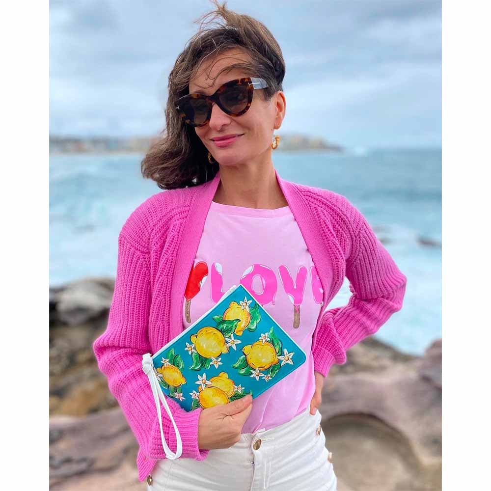 Citrone Pochette Bag Clutch worn by model dressed in pink at Bondi Beach Sydney