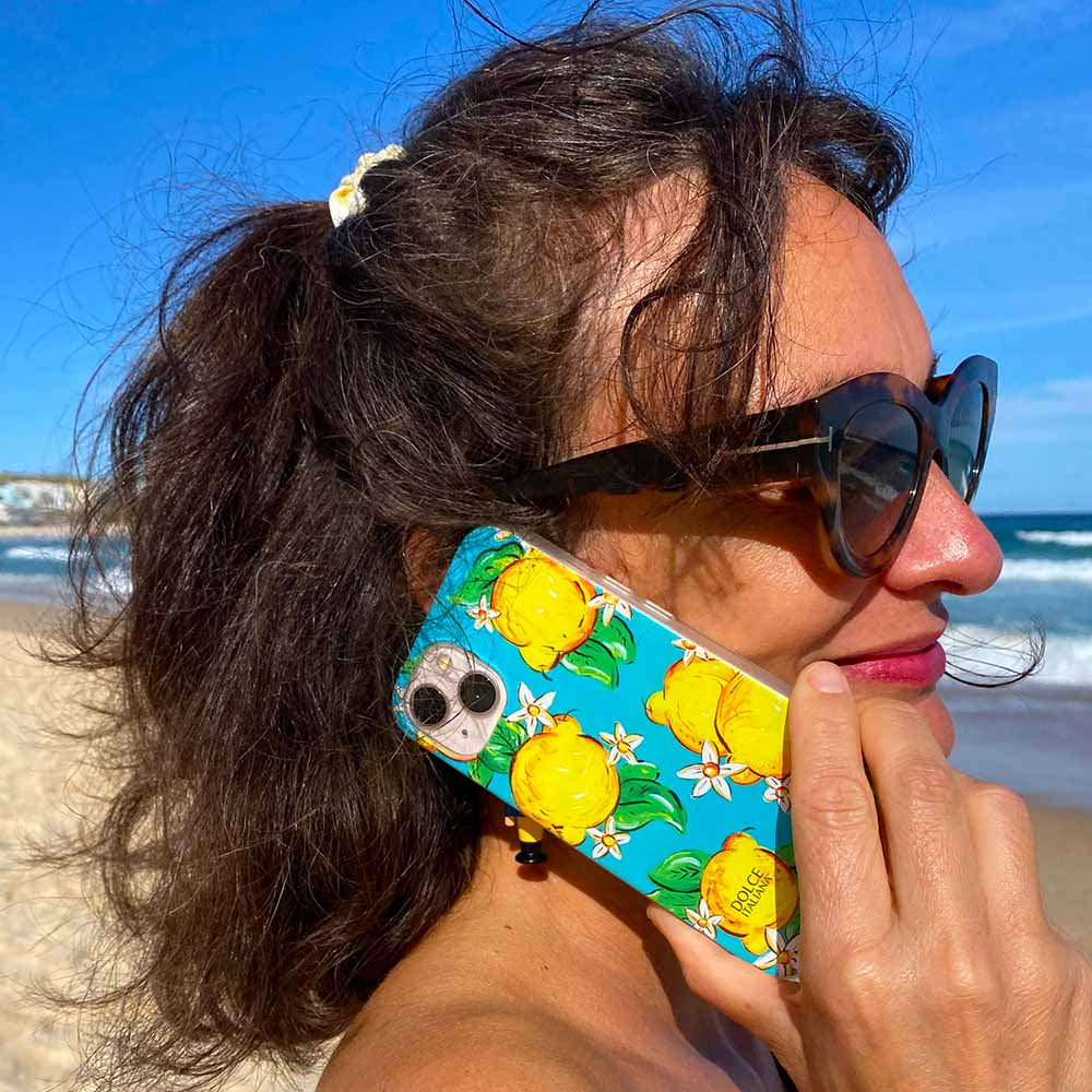 Amalfi lemons phone case held by model on beach