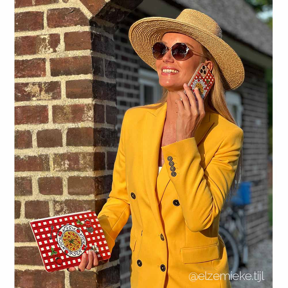 Red Vichy phone cover and clutch combination worn by model Elze Mieke Tijl