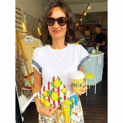 Model wears lemon and red white stripes bag by DOLCE ITALIANA at Bar Positano Sydney Australia