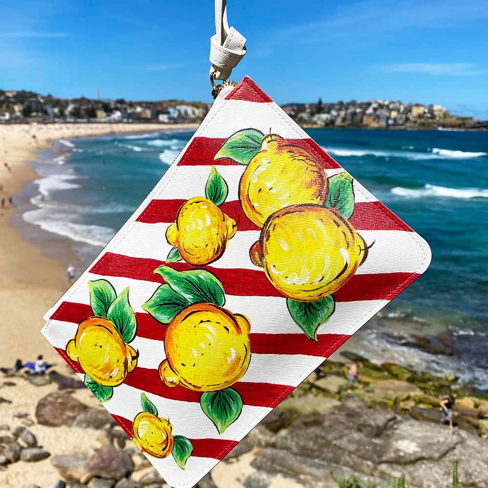 Lemon and red white stripes bag by DOLCE ITALIANA hanging out Bondi Beach Sydney Australia